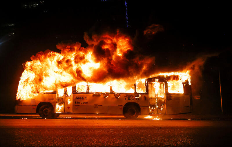 A bus is set on fire in Brasilia after a protest by Jair Bolsonaro's supporters. REUTERS/Adriano Machado