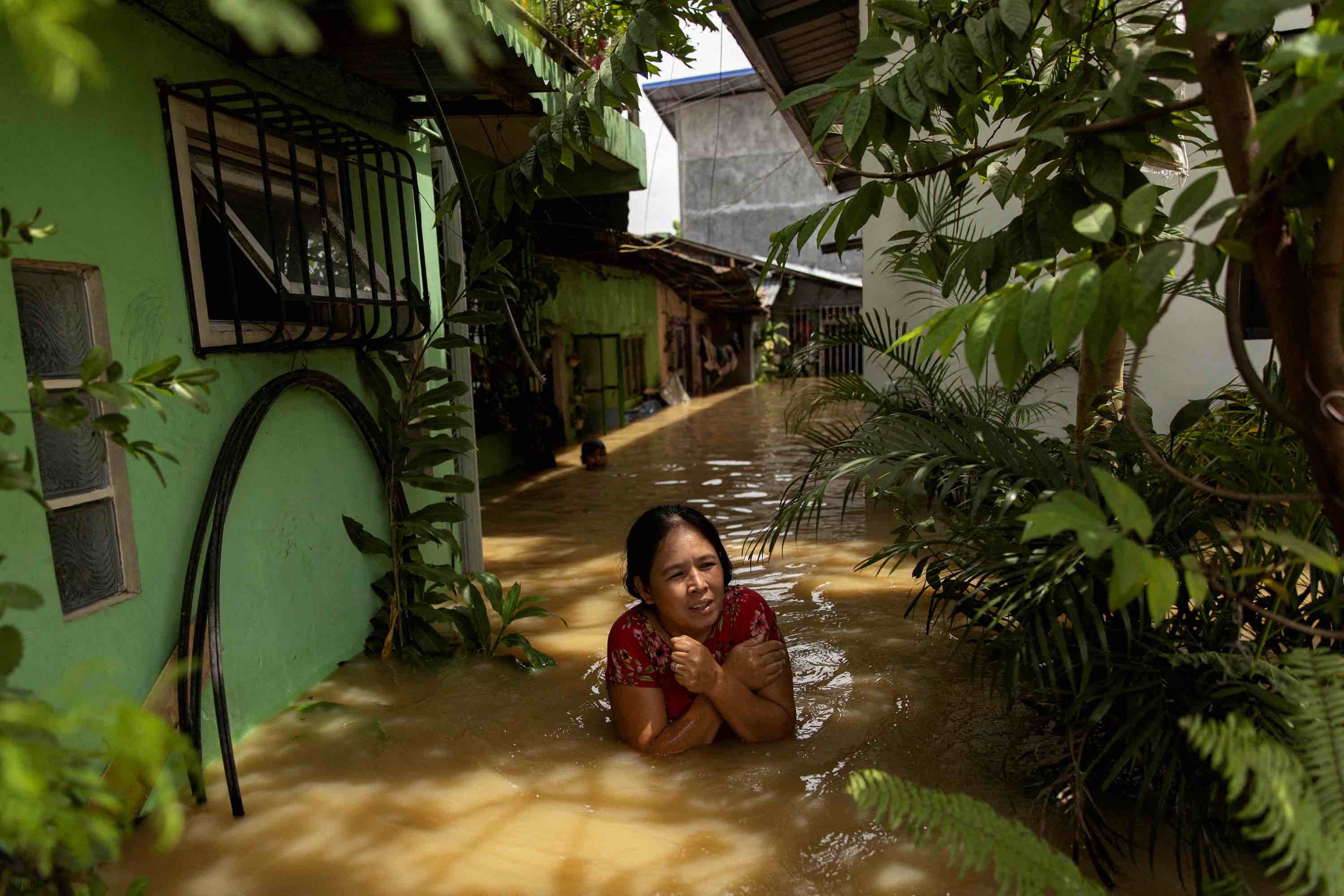 A woman wades through chest-deep flood after Super Typhoon Noru, in San Ildefonso, Bulacan province,Philippines, September 26, 2022. REUTERS/Eloisa Lopez.
