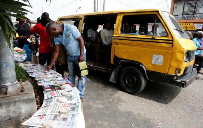 A man looks at newspapers at a vendor's stand in Lagos. REUTERS/Akintunde Akinleye
