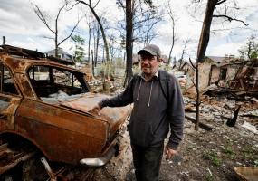 Oleksiy Sokolyuk, 50, talks to journalists as he shows his house, that according to him was destroyed by shelling, the first on March 5, and the second on March 17, amid Russian invasion of Ukraine, in Irpin, outside Kyiv, Ukraine May 4, 2022. REUTERS/Zohra Bensemra