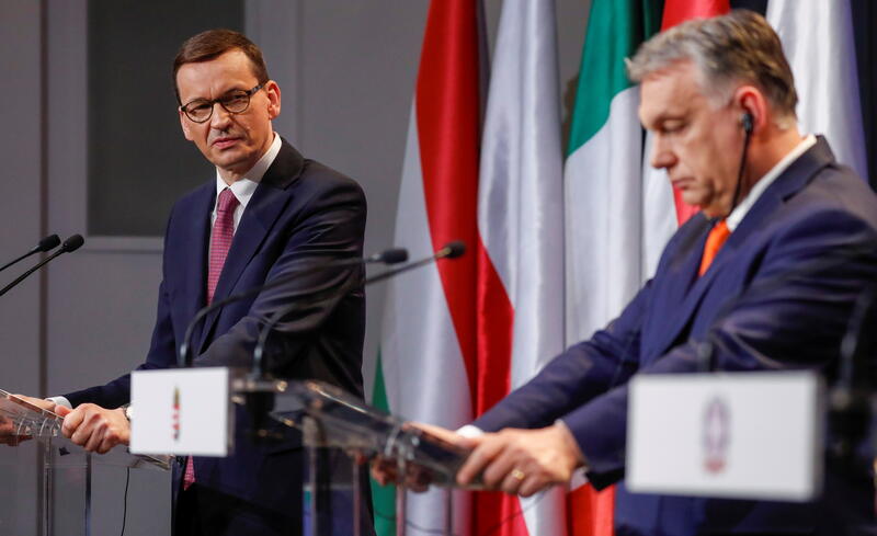 Hungary's Prime Minister Viktor Orban and Poland's Prime Minister Mateusz Morawiecki. REUTERS/Bernadett Szabo