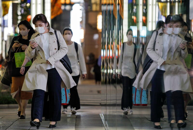 Passersby wearing protective masks walk on the street amid the coronavirus disease (COVID-19) outbreak in Tokyo, Japan, April 22, 2021. REUTERS/Androniki Christodoulou