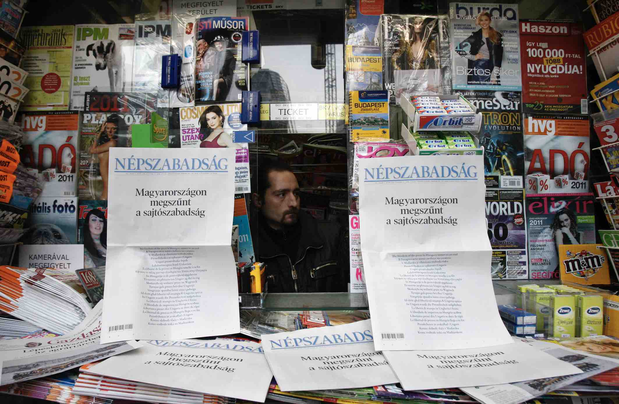 A Hungarian news agent look out from his stand in January 2011. The headline reads: "There is no longer press freedom in Hungary". Bernadett Szabo/Reuters