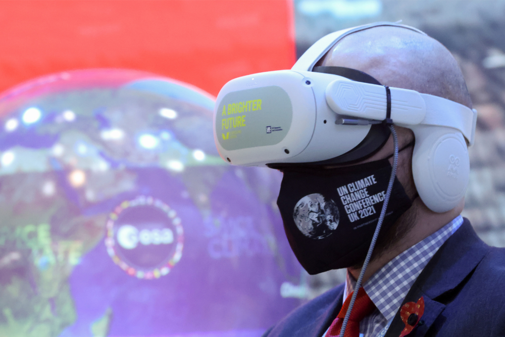 A delegate wears a VR headset at the media centre during the UN Climate Change Conference (COP26), in Glasgow, Scotland, Britain, November 4, 2021. REUTERS/Yves Herman