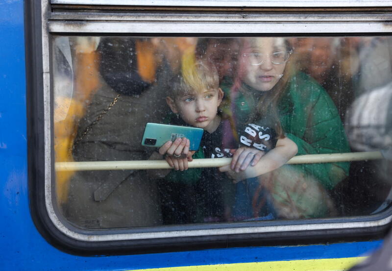A woman and her son look out from a train from Kyiv to Lviv. REUTERS/Umit Bektas 
