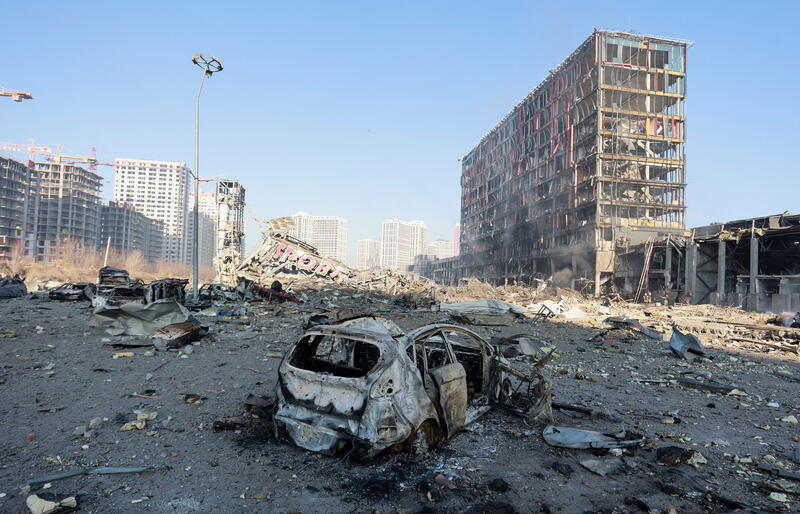 A view shows a destroyed car at the site of a shelling of a shopping center in the Podilskyi district of Kyiv, as Russia's invasion of Ukraine continues, in Kyiv, Ukraine March 21, 2022. REUTERS/Serhii Nuzhnenko