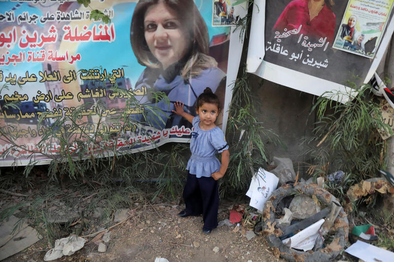 A Palestinian girl stands at the scene where Al Jazeera reporter Shireen Abu Akleh was shot dead during an Israeli raid, in Jenin, in the Israeli-occupied West Bank, July 3, 2022. REUTERS/Raneen Sawafta