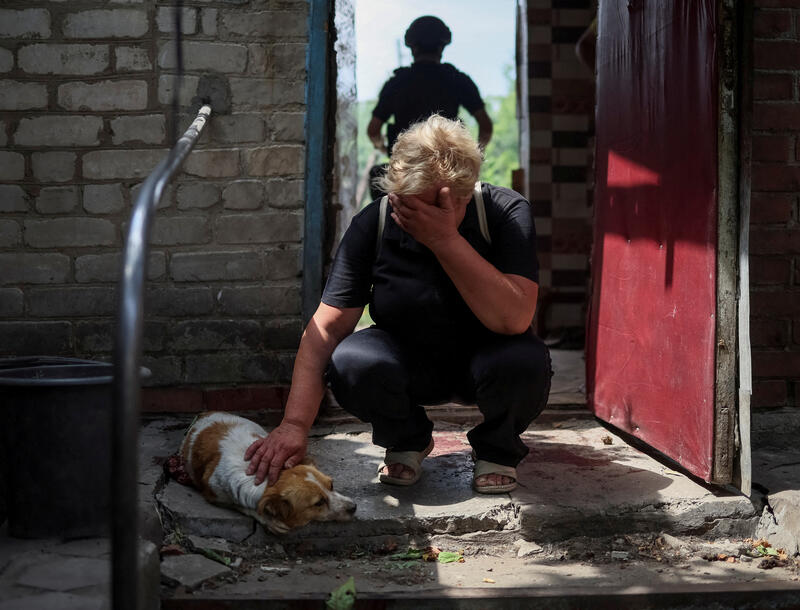 Lena, 58, reacts near her critically wounded dog Hera, during a Russian military strike, as Russia's attack on Ukraine continues, in Kostiantynivka, Ukraine July 9, 2022. REUTERS/Gleb Garanich TPX IMAGES OF THE DAY