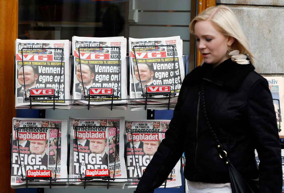 A woman in Norway walks past a newsstand displaying VG and Dagenbladt tabloids. REUTERS/Stoyan Nenov
