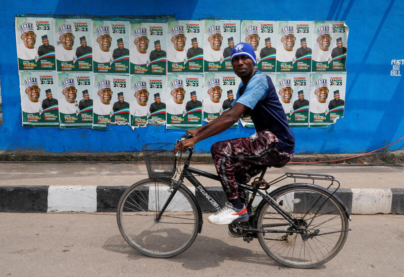 A man rides a bicycle past electoral campaign posters in Lagos, Nigeria. REUTERS/Temilade Adelaja