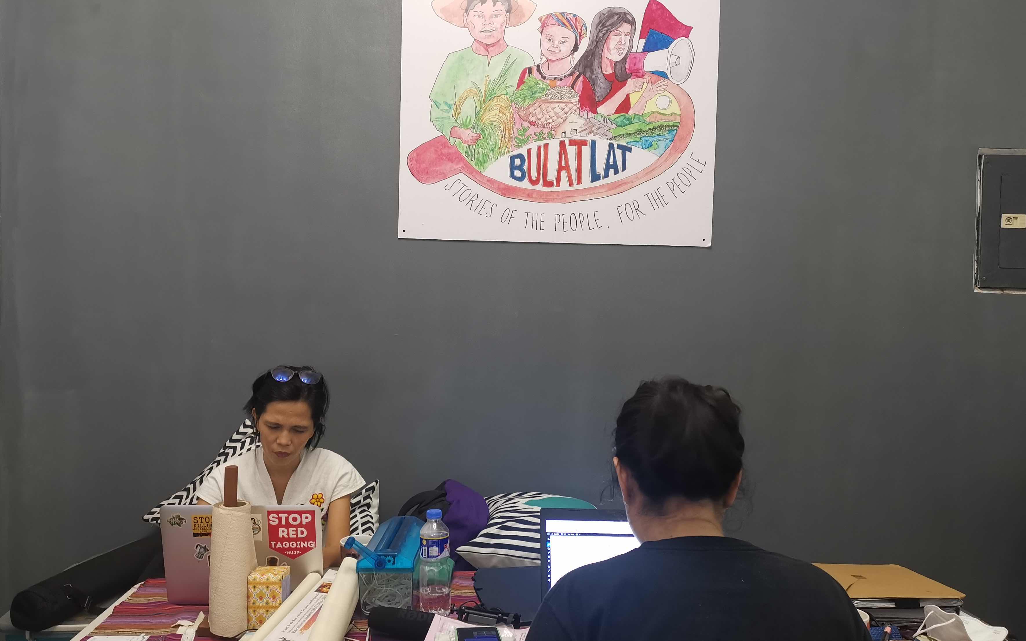 Two journalists work at the Bulatlat newsroom. 
