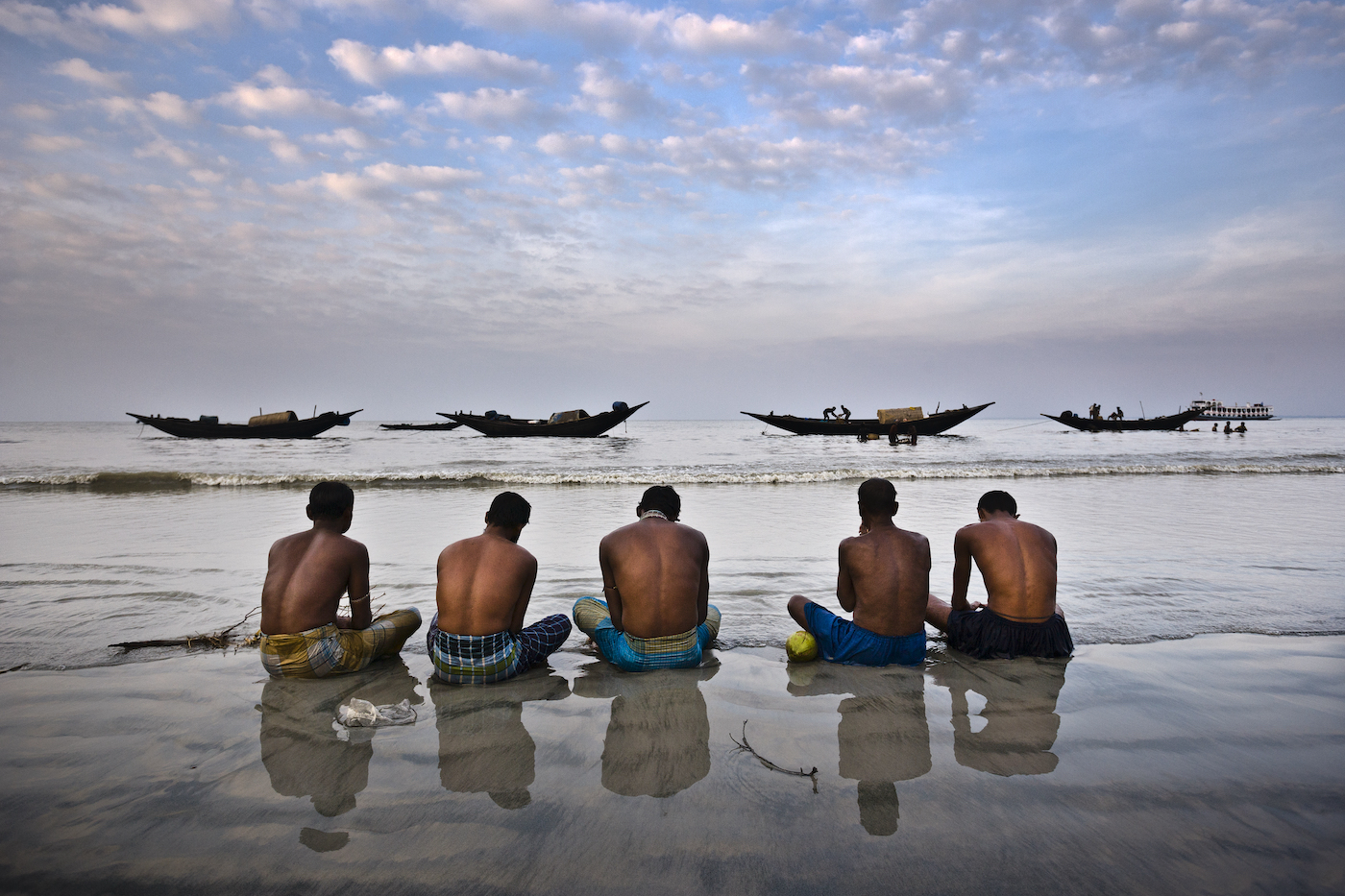 Rodney Dekker / Climate Visuals  Five fishermen pray for a benevolent sea in Dublar, Bangladesh, one year after Cyclone Sidr hit the region. On November 15th, 2007, one of the strongest cyclones ever to hit the country slammed into the remote island of Dublar, killing thousands of fishermen out at sea. 