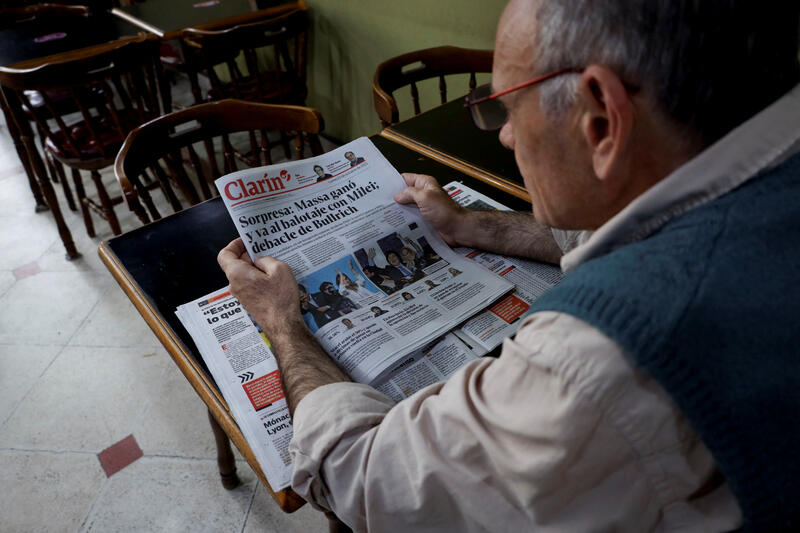 A man reads a newspaper, a day after the first round of Argentina's presidential election, in Buenos Aires, Argentina October 23, 2023. REUTERS/Cristina Sille