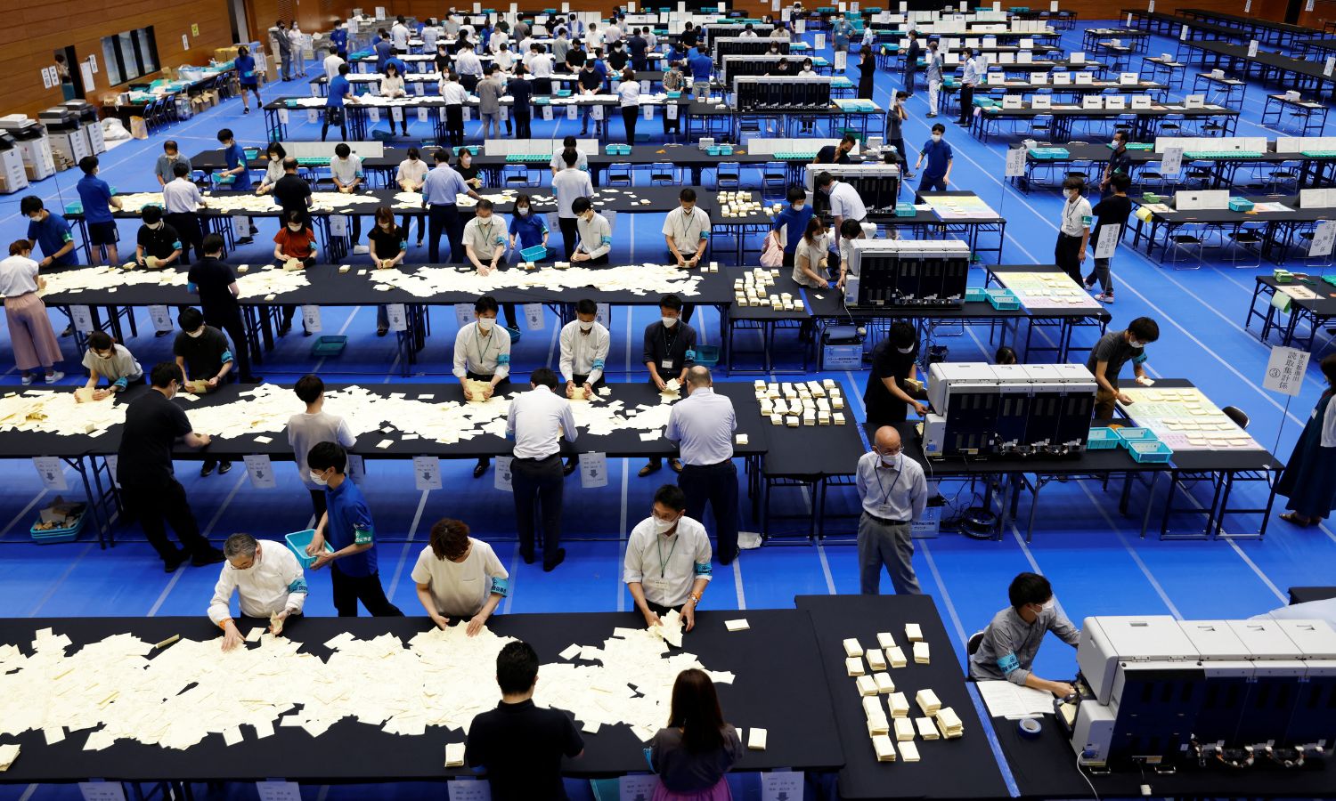 Election officials count votes at a ballot counting centre for Japan’s upper house election in Tokyo, Japan, July 10, 2022. REUTERS/Issei Kato.