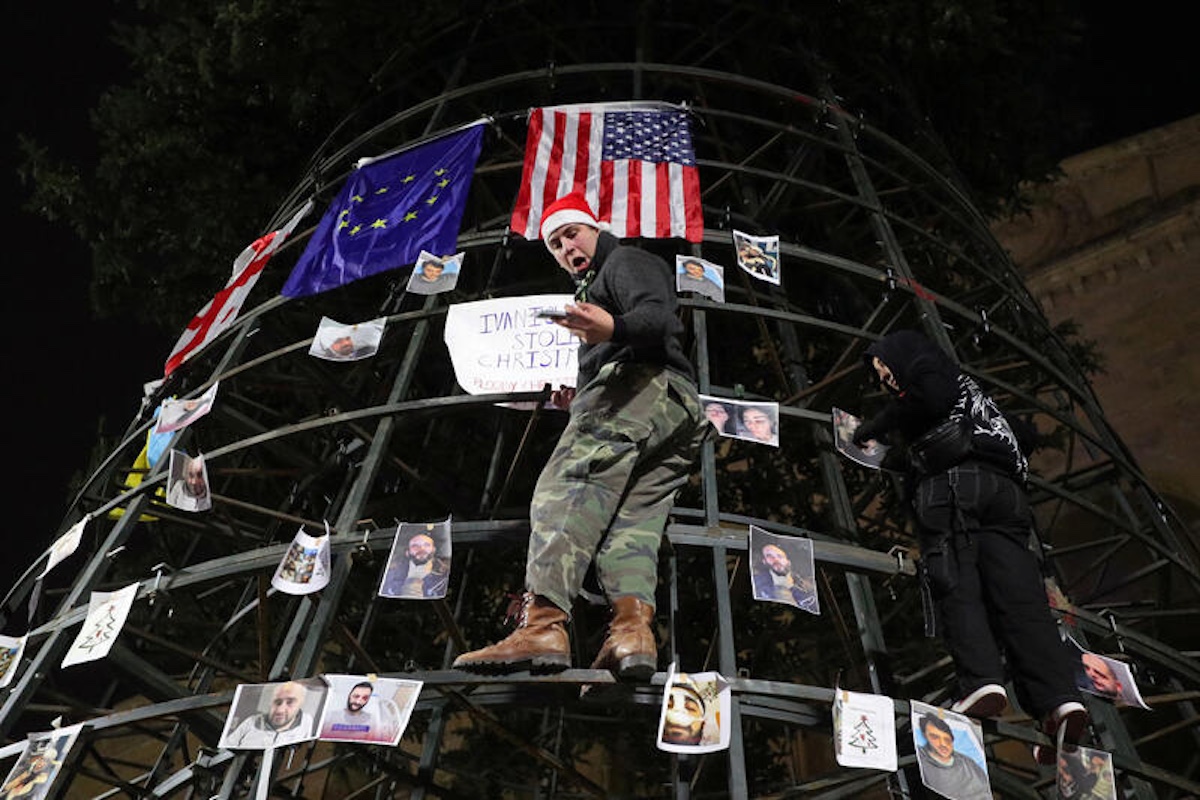 Demonstrators hang pictures of protesters and journalists injured during protests against the Georgian government's decision to suspend talks on joining the European Union on the frame of a Christmas tree in Tbilisi, Georgia December 8, 2024. REUTERS/Irakli Gedenidze