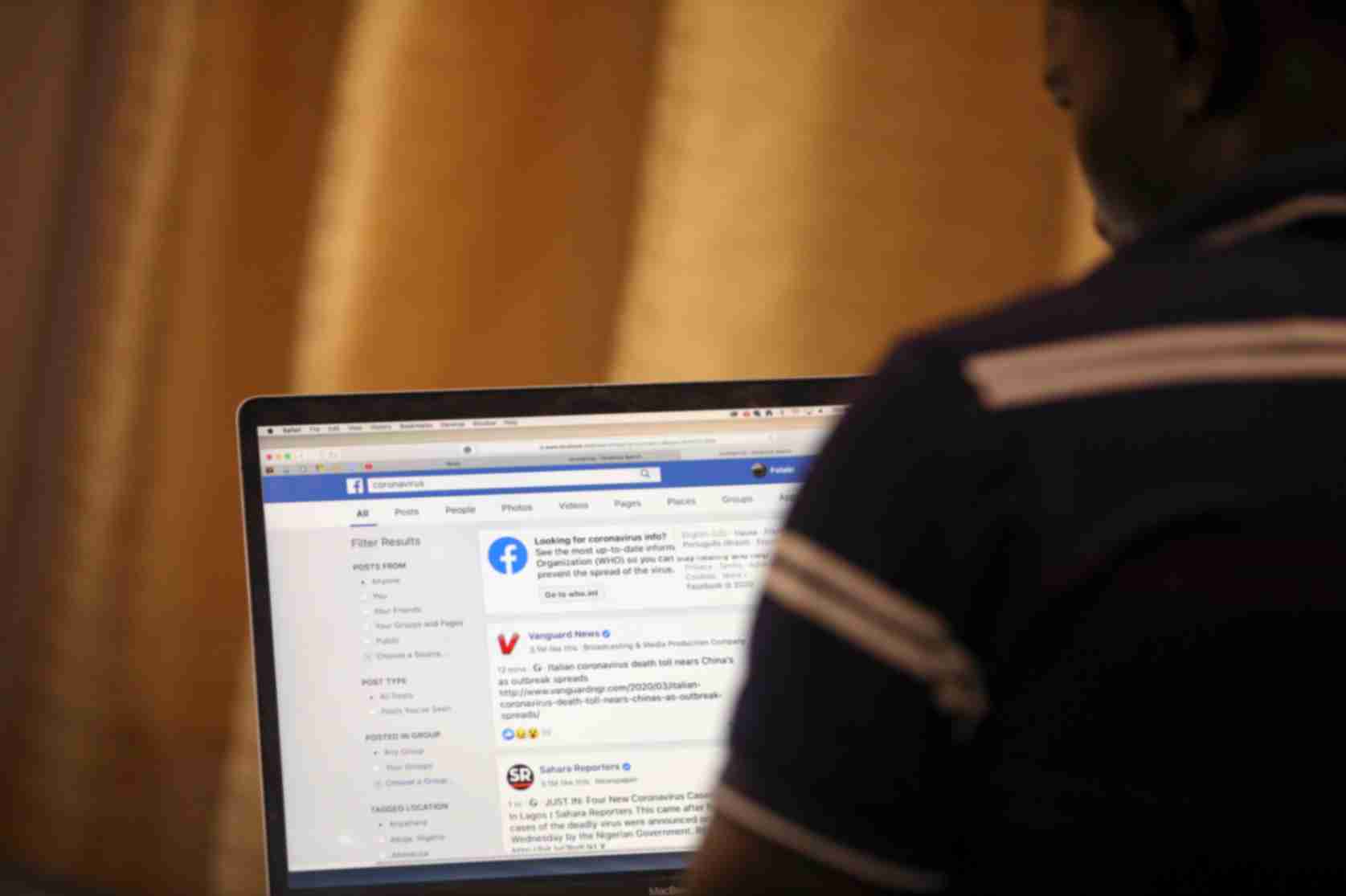 A man opens the Facebook page on his computer to fact check coronavirus disease (COVID-19) information, in Abuja, Nigeria March 19, 2020. Picture taken March 19, 2020. REUTERS/Afolabi Sotunde