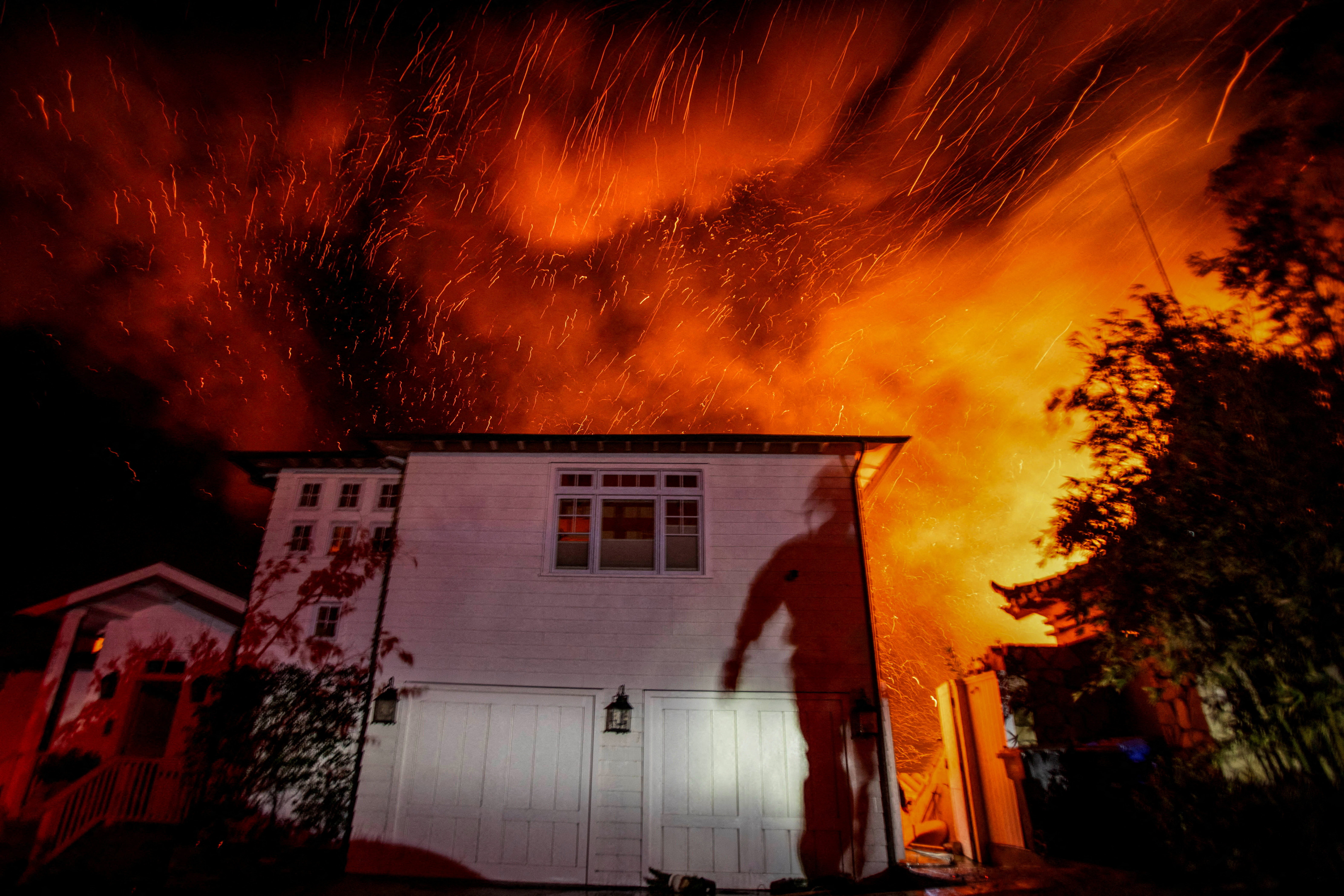 The wind whips embers as the Palisades fire burns during a windstorm on the west side of Los Angeles, January 8. REUTERS/Ringo Chiu