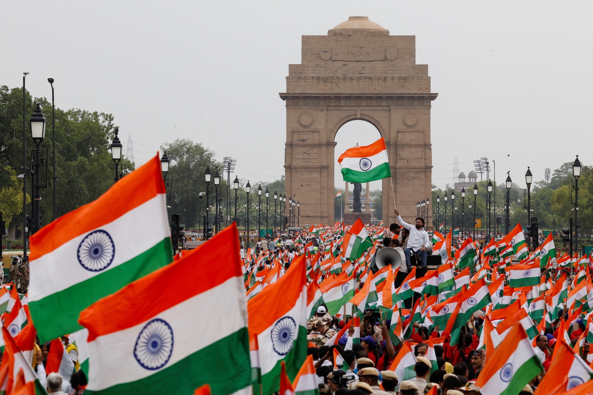 People wave Indian flags in support of the Indian Armed Forces, following the ceasefire announcement between India and Pakistan, in Delhi, India, May 13, 2025. REUTERS/Priyanshu Singh