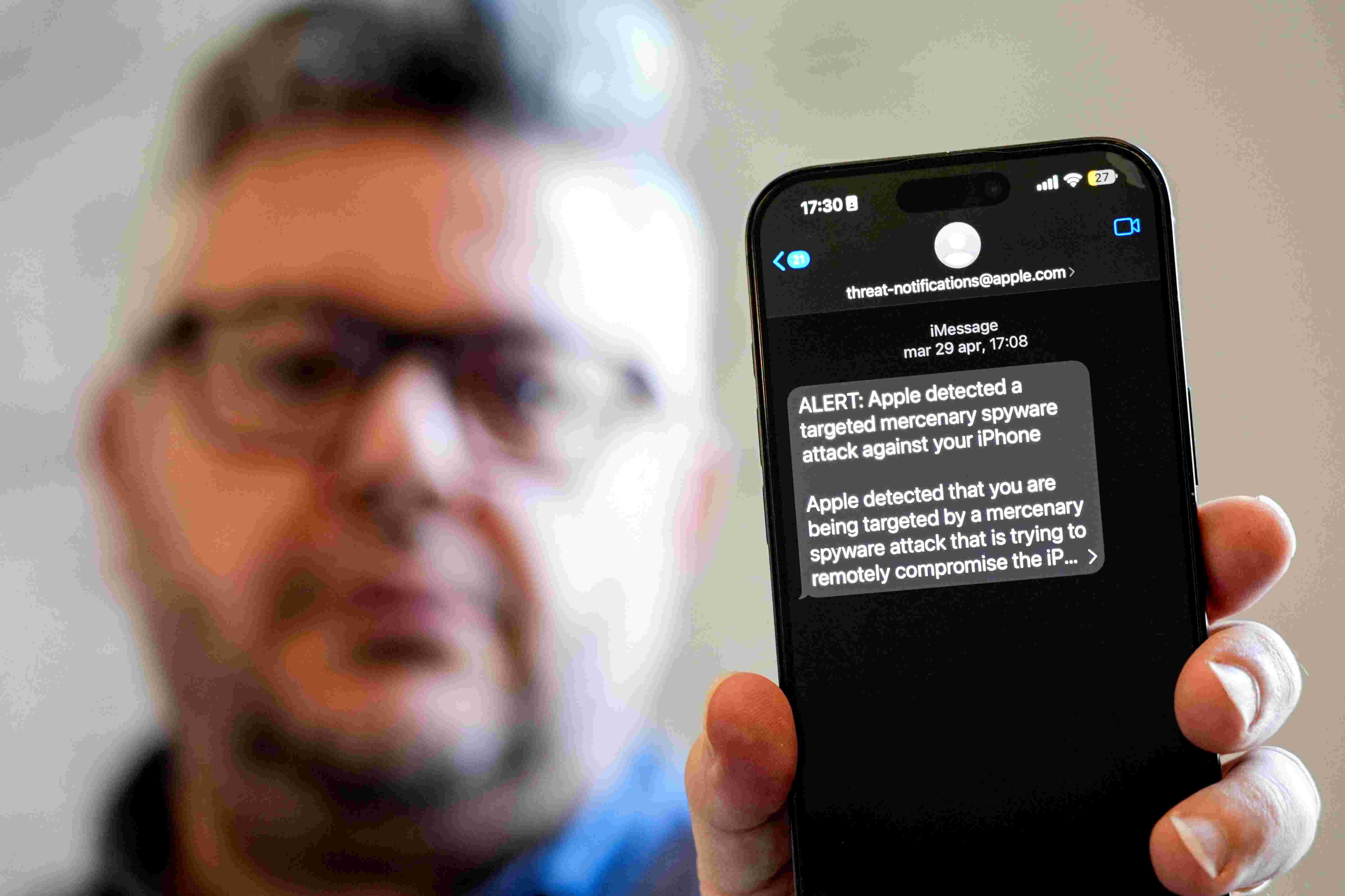 Ciro Pellegrino shows his phone screen displaying a threat notification from Apple warning of a mercenary spyware attack