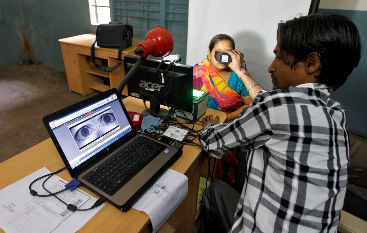 Woman in India undergoing iris scan for government rations and digital payments authentication.
