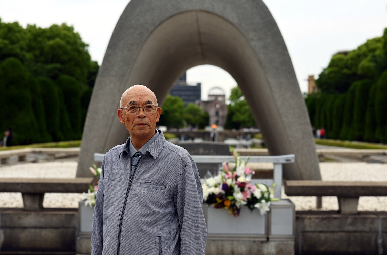 Kunihiko Sakuma, an atomic bomb survivor and chair of the Hiroshima Prefectural Confederation of A-bomb Sufferers Organizations (Hiroshima Hidankyo), poses for a photograph in front of the Cenotaph for the Victims of the Atomic Bomb at the Hiroshima Peace Memorial Park in Hiroshima, western Japan June 11, 2025. REUTERS/Issei Kato