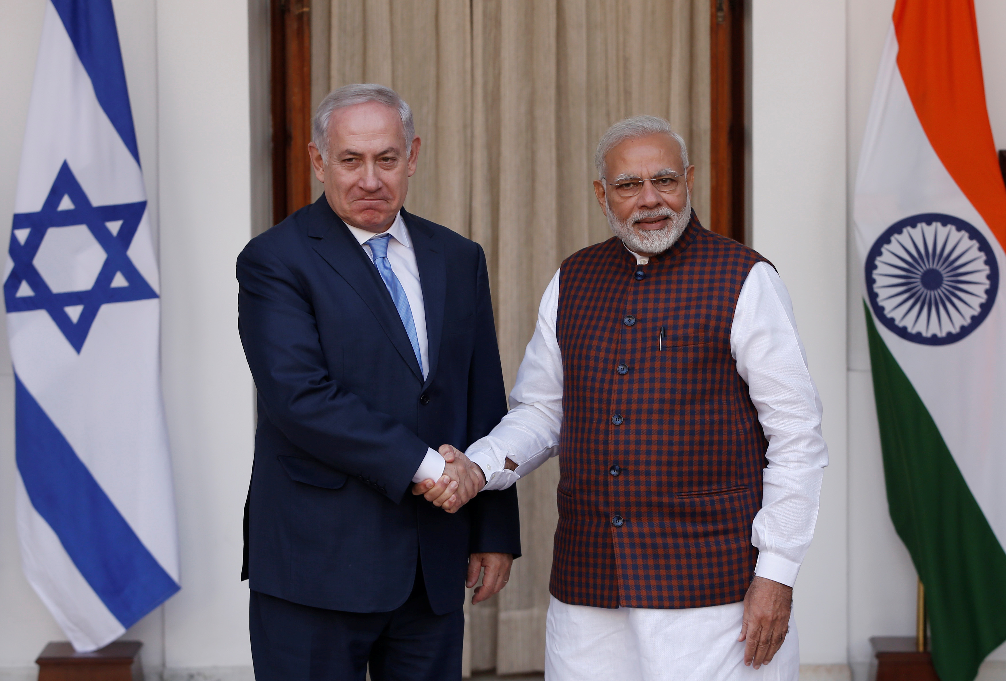 Israeli Prime Minister Benjamin Netanyahu shakes hands with his Indian counterpart Narendra Modi during a photo opportunity ahead of their meeting at Hyderabad House in New Delhi, India, January 15, 2018. REUTERS/Adnan Abidi