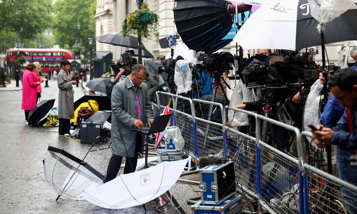 Members of the media work outside Number 10 Downing Street in London