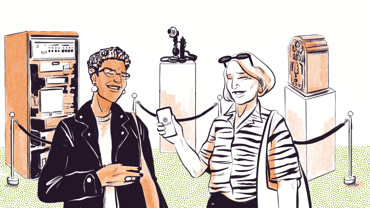 An older black woman in a leather jacket and short hair is laughing with her friend, an older white woman in a zebra print blouse with bobbed hair and sunglasses on her head are both laughing. They are standing in front of a display of past technological inventions - a computer server, a telephone and a wireless radio. The white woman is holding a mobile phone, chat ChatGPT is loaded on the screen. The women are comparing ChatGPT to previous technological breakthroughs.