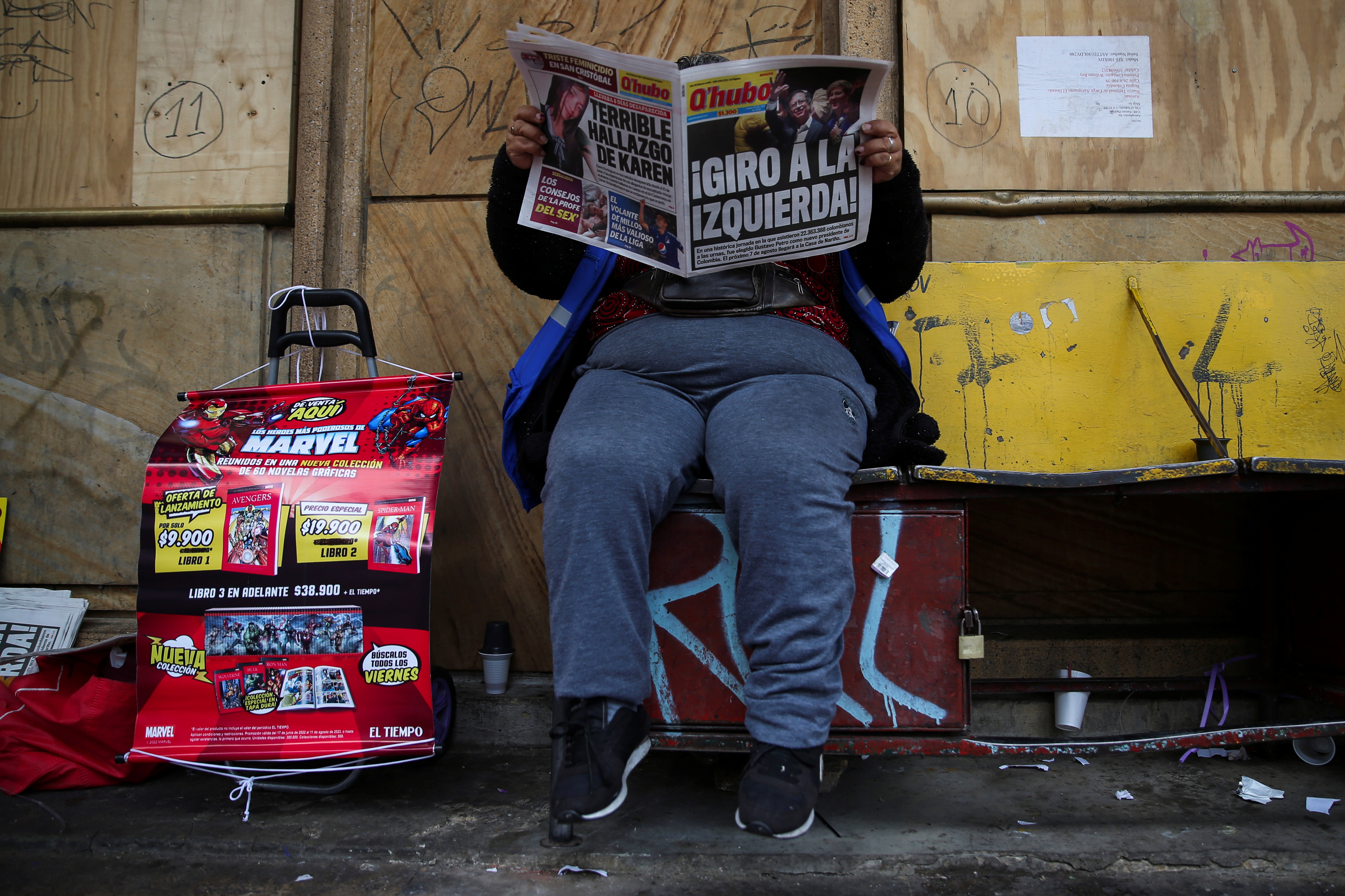 A woman reads a newspaper showing the results of the second round of presidential election the morning after the voting took place, in Bogota, Colombia June 20, 2022. REUTERS/Luisa Gonzalez