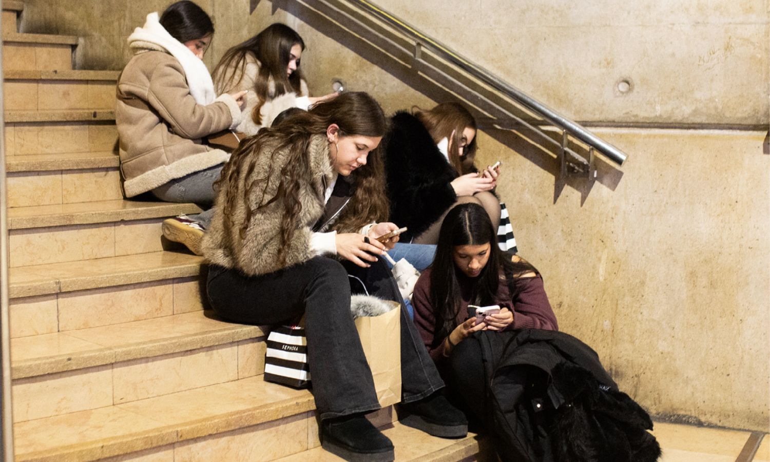A group of young women on their phones