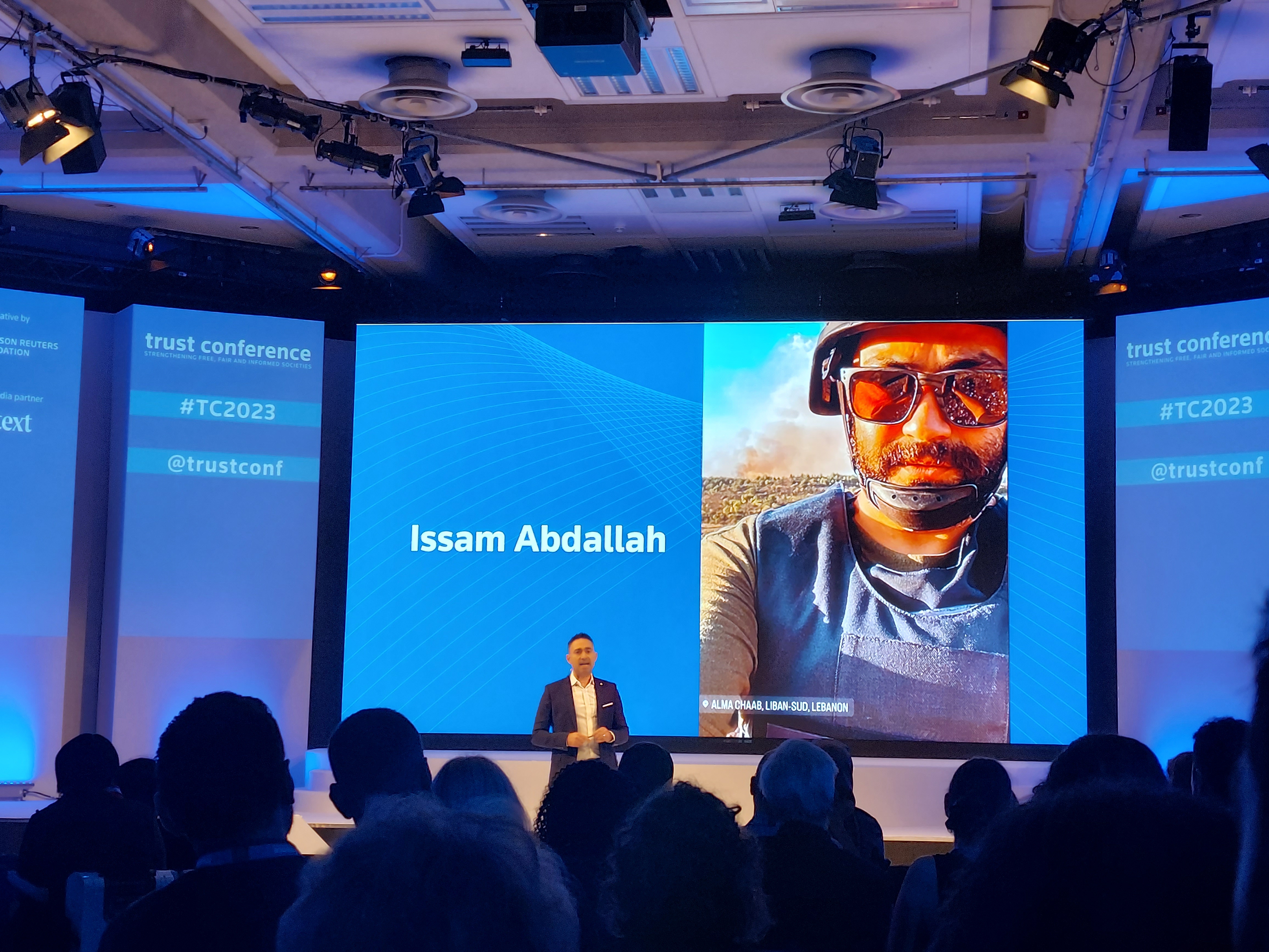 TRF CEO Antonio Zappulla stands in front of a screen showing the face of Issam Abdallah.