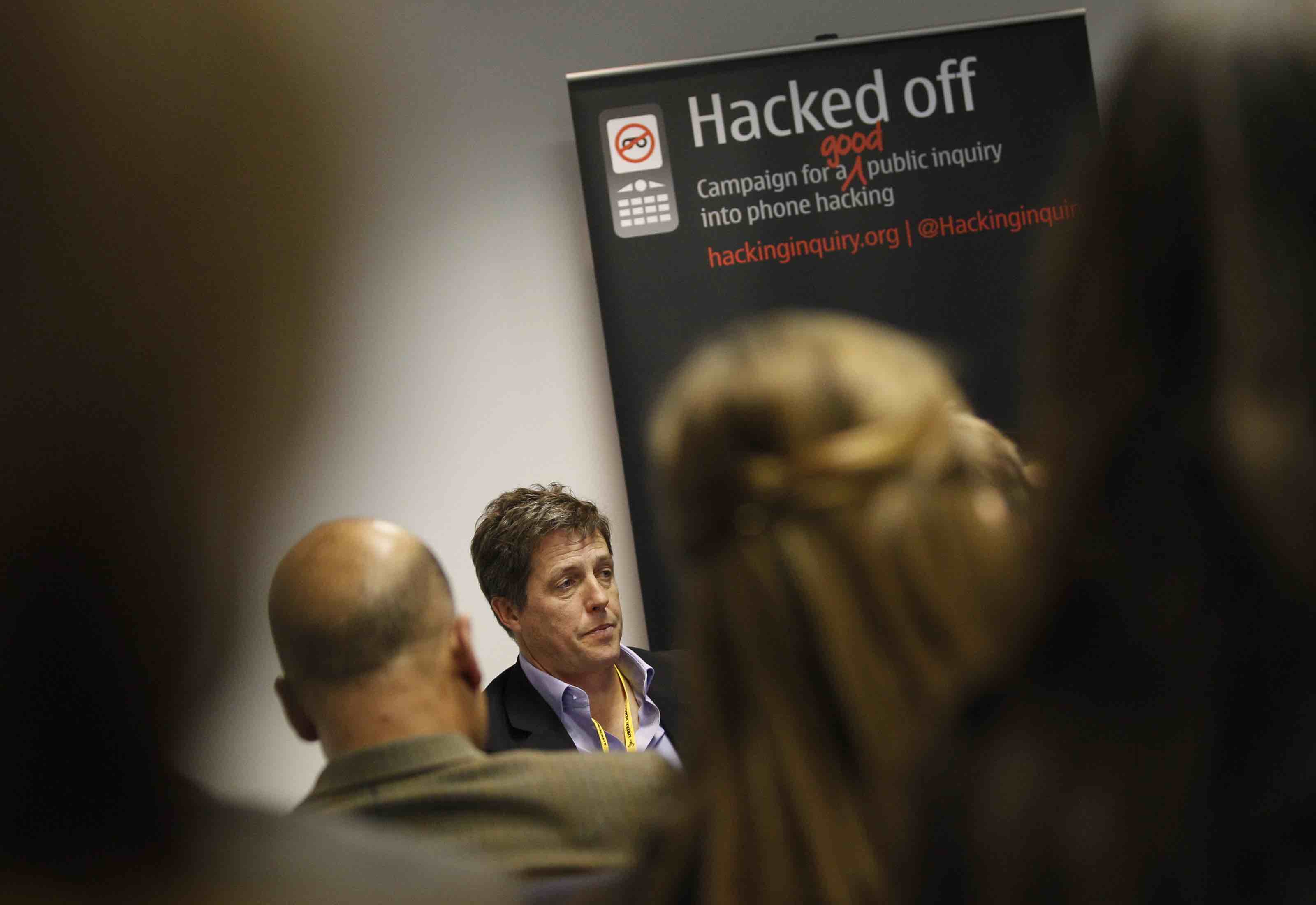 Hugh Grant (C) speaks at a news conference during the Liberal Democrats annual autumn conference in Birmingham, central England September 18, 2011. The news conference was organised by "Hacked Off", which is calling for a full public inquiry into the phone hacking scandal. REUTERS/Darren Staples