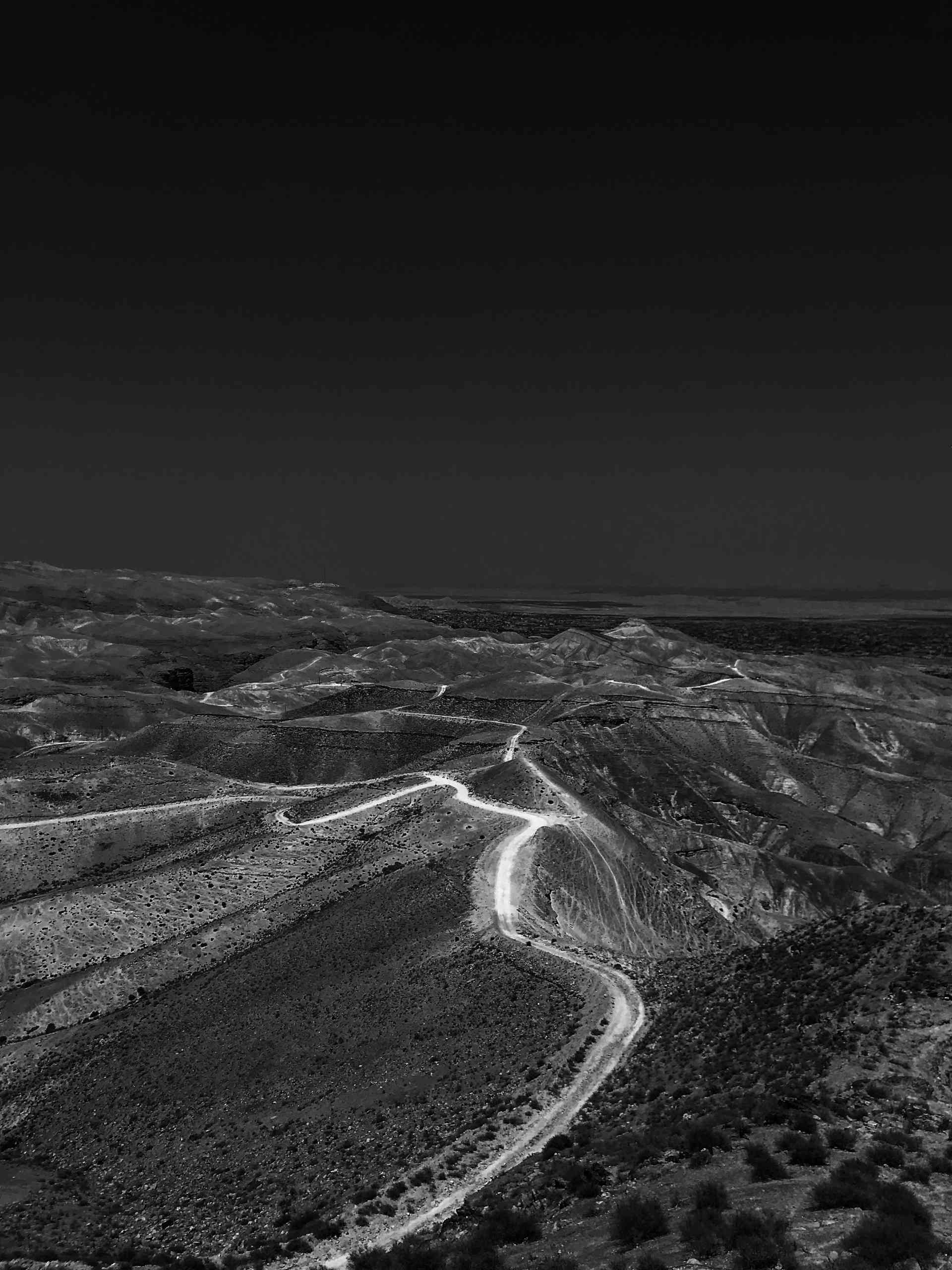 A black and white photo of a rugged landscape