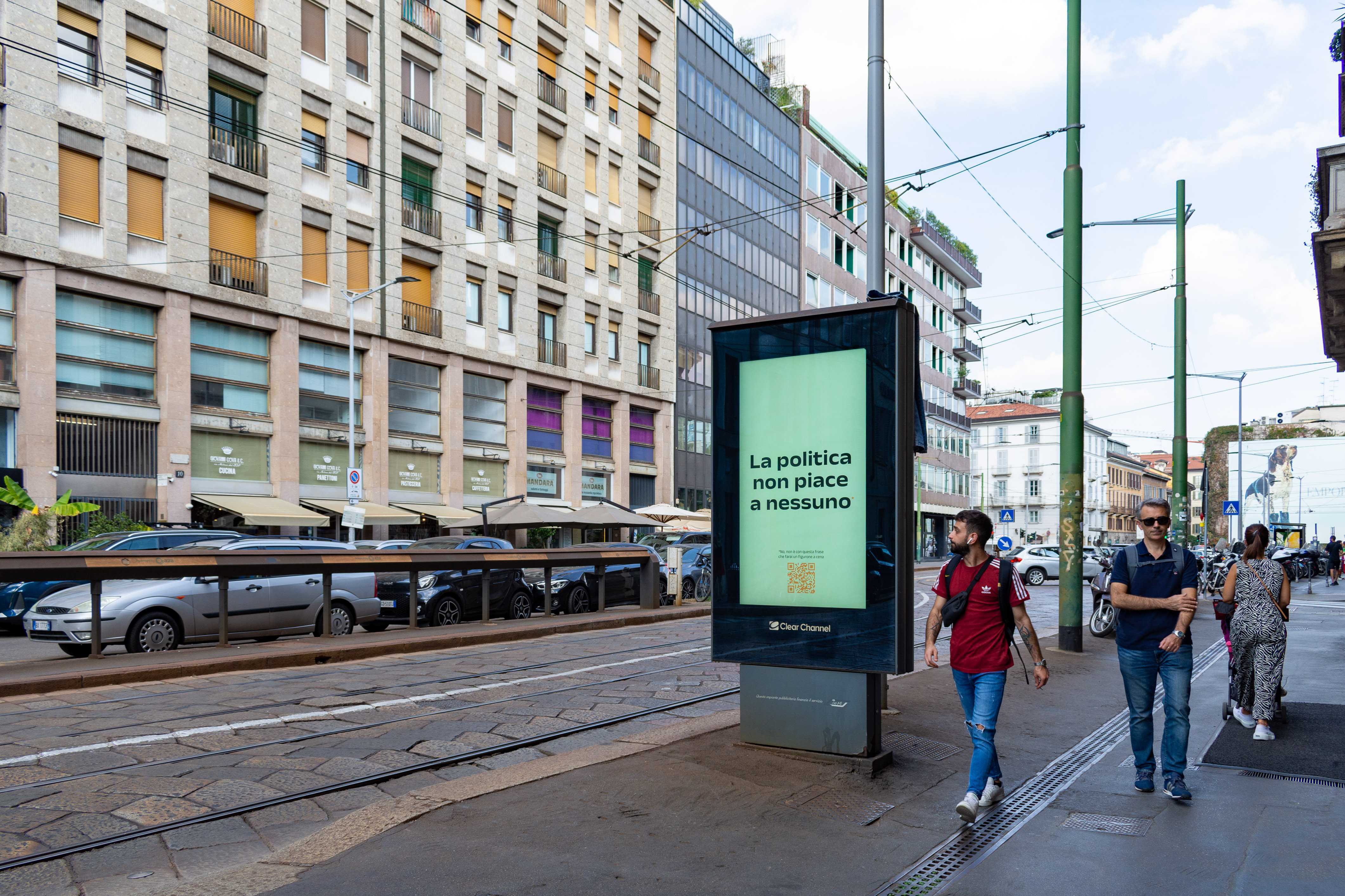 A man looks at a Will Media 'Nobody likes politics' electronic billboard as he walks past.