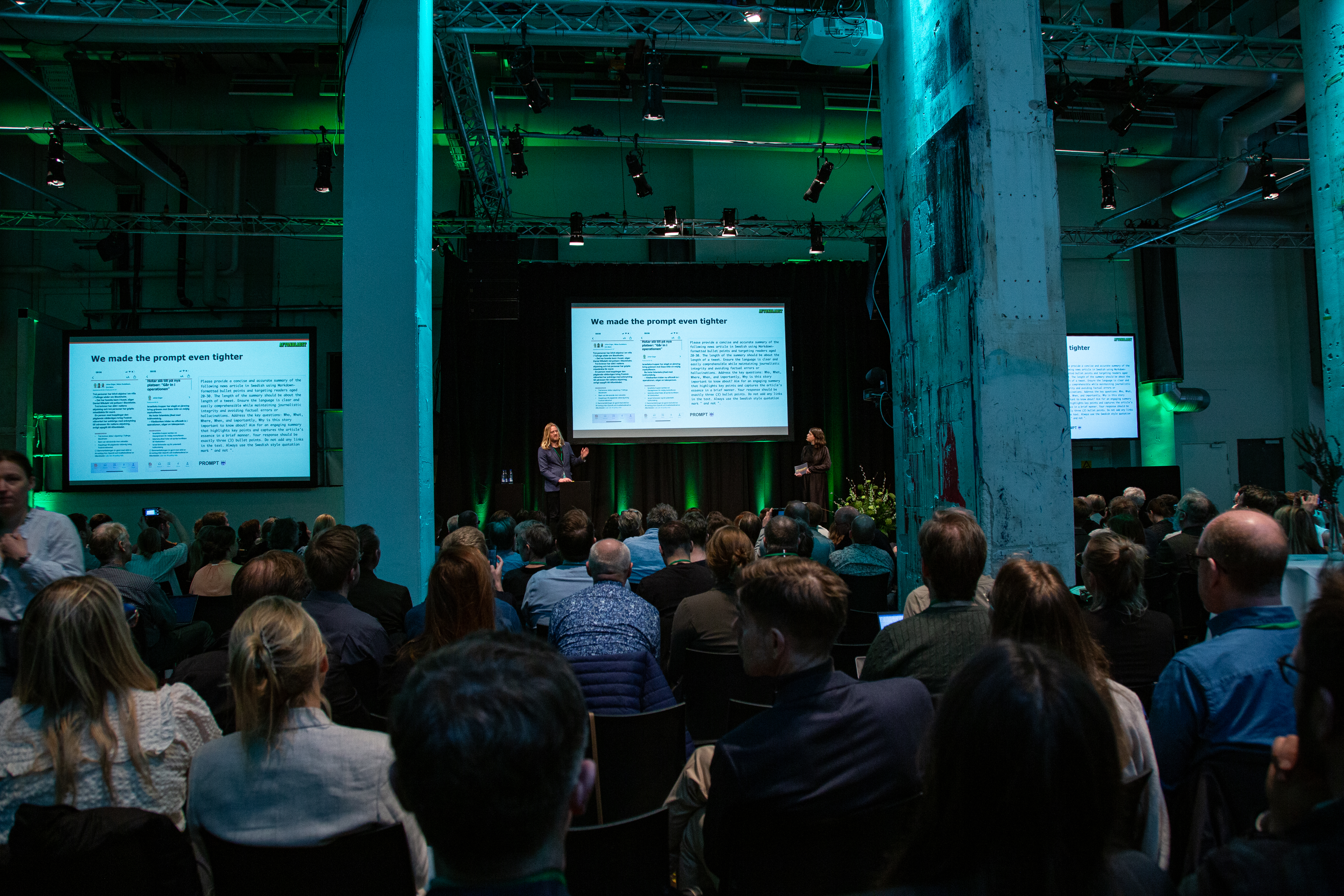 A photograph of Martin Schori and Elin Wieslander presenting their project on stage at the summit.