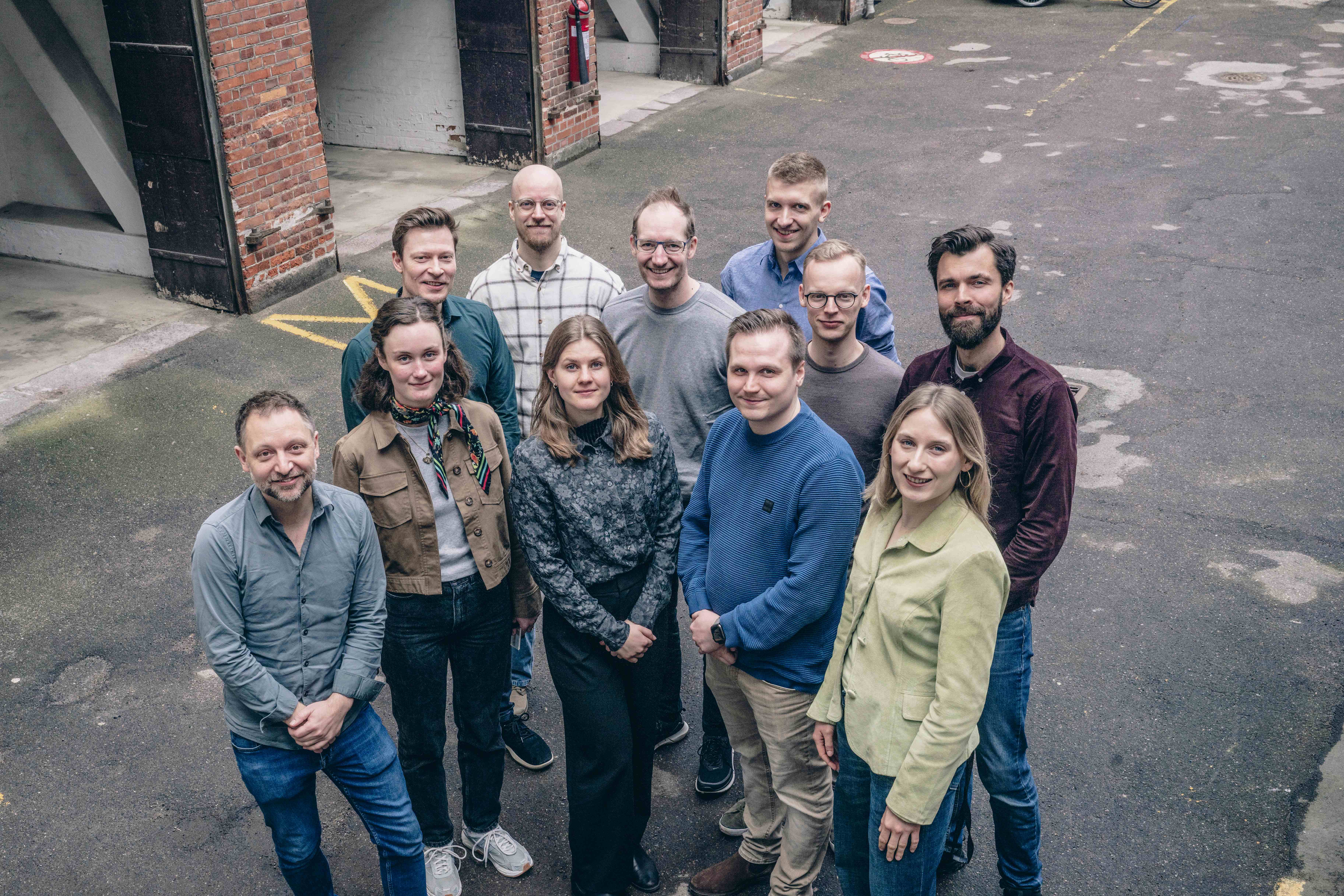 A photograph taken from above of a group of people smiling