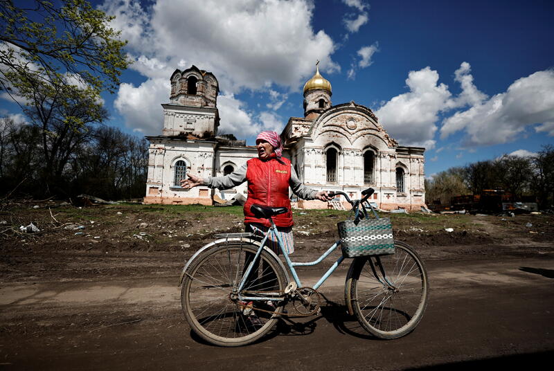 Nadia Denysevych, 62, talks to journalists in front of the destroyed church that according to residents was used by the Russian Army as a munitions warehouse in Lukashivka, Chernihiv region, Ukraine April 27, 2022. REUTERS/Zohra Bensemra