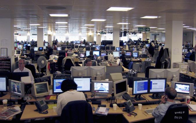 Employees work in the Reuters newsroom in the Canary Wharf district of London. REUTERS/Simon Newman