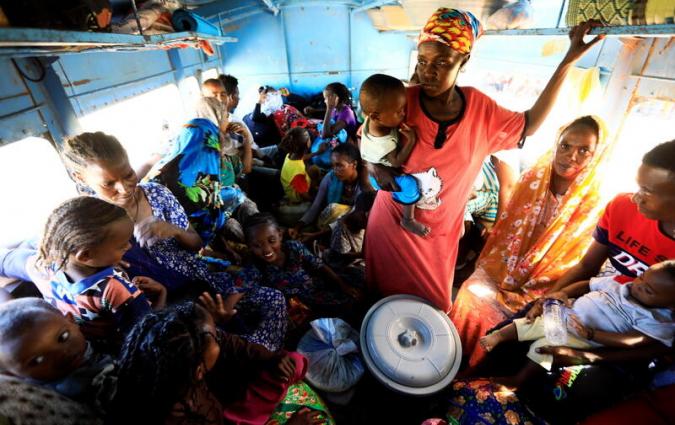Ethiopian refugees who fled Tigray region, sit inside a courtesy bus at the Fashaga camp as they are transferred to Um-Rakoba camp on the Sudan-Ethiopia border, in Kassala state, Sudan December 13, 2020. REUTERS/Mohamed Nureldin Abdallah