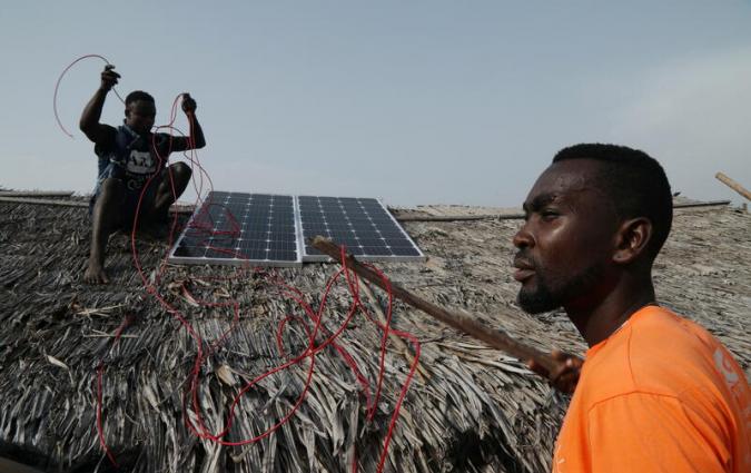 PEG Africa agents prepare to install a solar-powered fridge panel in Lahou-Kpanda, Ivory Coast, February 25, 2021. Photo taken on February 25, 2021. REUTERS / Luc Gnago