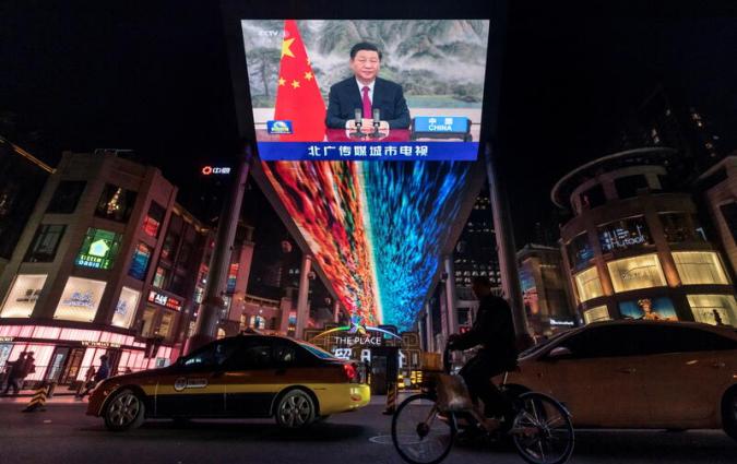 A screen displays a CCTV state media news broadcast showing Chinese President Xi Jinping addressing world leaders at the G20 meeting in Rome via video link at a shopping mall in Beijing, China, October 31, 2021. REUTERS/Thomas Peter