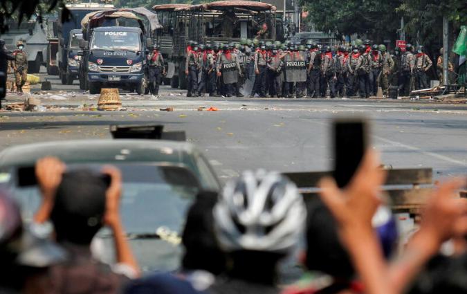 Police stand on a road during an anti-coup protest in Mandalay, Myanmar, March 3, 2021. REUTERS