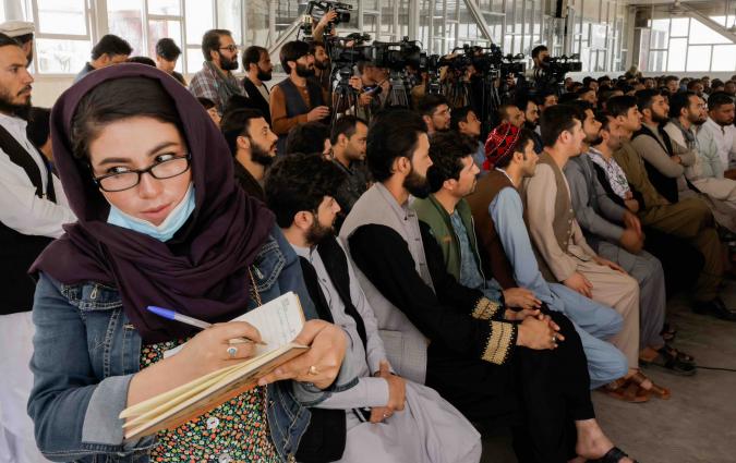 An Afghan female journalist attends a Taliban officials news conference where they announced they will start issuing passports to its citizens again following months of delays that hampered attempts by those trying to flee the country after the Taliban seized control, in Kabul, Afghanistan October 5, 2021. REUTERS/Jorge Silva