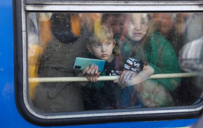 A woman and her son look out from a train from Kyiv to Lviv. REUTERS/Umit Bektas 
