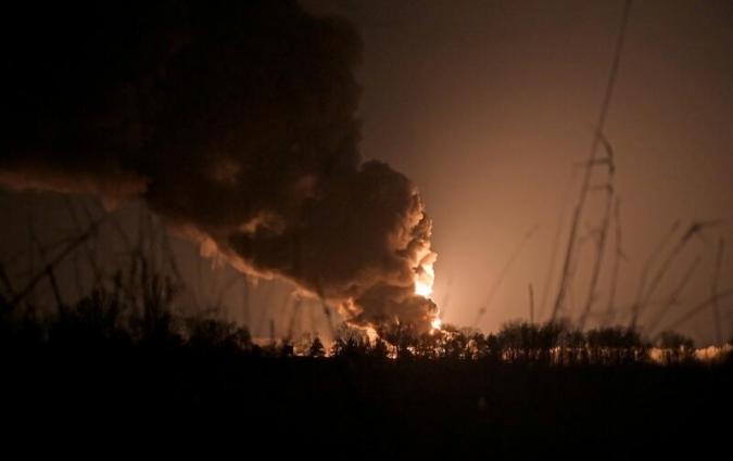 A view shows a burning oil depot reportedly hit by shelling near the military airbase Vasylkiv in the Kyiv region, Ukraine February 27, 2022. REUTERS/Maksim Levin