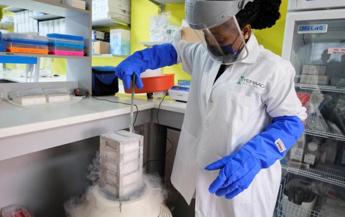 Vera Kotey, 22, a research associate, inspects a liquid nitrogen tank at Yemaachi Biotechnology, a cancer research laboratory in Accra, Ghana May 19, 2022. Picture taken May 19, 2022. REUTERS/Francis Kokoroko