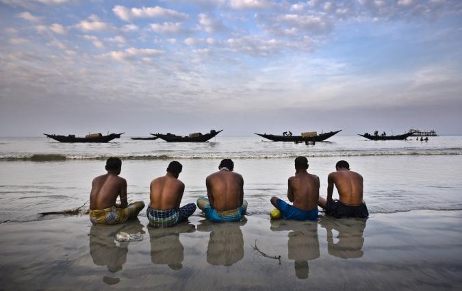 Rodney Dekker / Climate Visuals  Five fishermen pray for a benevolent sea in Dublar, Bangladesh, one year after Cyclone Sidr hit the region. On November 15th, 2007, one of the strongest cyclones ever to hit the country slammed into the remote island of Dublar, killing thousands of fishermen out at sea. 