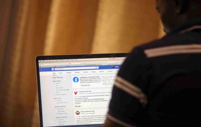 A man opens the Facebook page on his computer to fact check coronavirus disease (COVID-19) information, in Abuja, Nigeria March 19, 2020. Picture taken March 19, 2020. REUTERS/Afolabi Sotunde
