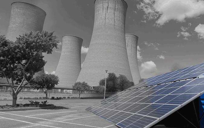 solar panels in the foreground, and the now-defunct Komati coal chimney stacks in the background