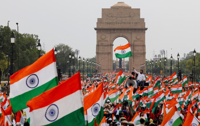 People wave Indian flags in support of the Indian Armed Forces, following the ceasefire announcement between India and Pakistan, in Delhi, India, May 13, 2025. REUTERS/Priyanshu Singh